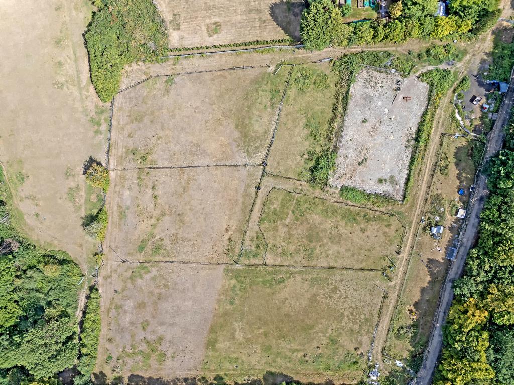 Lot: 72 - VACANT LAND IN VILLAGE LOCATION - Aerial drone shot of the land